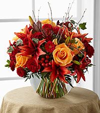 a vase filled with orange and red flowers