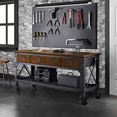 an industrial workbench with tools hanging on the wall