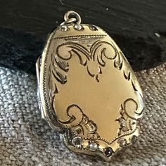 "A Vintage fancy shield shaped Lockewt Gold-filled, paste jewels, lovely hand end engraved design.  Condition is good for its Age any slight wear or age to stones commensurate with age-photos show the details.  size 1 1/8\" by 7/8\", closes tight, hinge is good, inside clean.  If you love vintage lockets this is Treasure from the past." Luxury Vintage Keepsake Necklaces, Vintage Diamond Medallion Jewelry, Victorian Medallion Diamond Jewelry, Victorian Diamond Medallion Jewelry, Vintage White Gold Filigree Jewelry, Bronze Vintage Charm Jewelry For Anniversary, Antique Bronze Jewelry For Anniversary, Antique Finish Bronze Jewelry For Anniversary, Bronze Jewelry With Vintage Charm For Anniversary