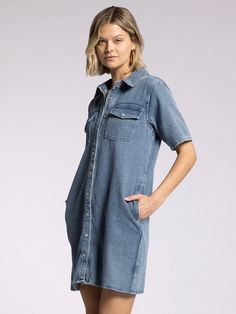 Style Description: FINAL SALE Designed a classic point collar, short sleeves, and snaps along the front, this denim mini shirtdress has dual side and patch pockets. Dress it up with boots or go casual in your favorite sneakers. Collared neckline Button front closure Multiple pockets Measurements for a size small: Length: 35.5" Chest: 20" Sweep: 21.5" Fabric Content/Care: 100% Cotton Machine Wash ColdImport Relaxed Fit Collared Denim Dress, Phoenix Dress, Everyday Pants, Button Down Shirt Dress, Knit Outerwear, Sweater Tank Top, Denim Button Down, Dress Trousers, Denim Mini