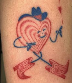 a heart with an arrow and bow tattoo on someone's leg