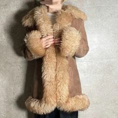 Elevate your winter wardrobe with the Penny Lane Coat--a luxurious long shearling coat for women that exudes timeless boho chic. This brown Afghan-inspired fur coat, crafted from premium sheepskin and suede, offers the perfect blend of warmth and style. Its bohemian design, reminiscent of classic 70s hippie fashion, makes it a standout piece for any cold-weather ensemble. Whether you're embracing a vintage-inspired look or adding a touch of elegance to your boho outfits, this wool coat is the ultimate winter essential. Stay cozy and stylish all season long with this must-have bohemian winter jacket. Details: 1- Material: Crafted from genuine suede leather for a durable and luxurious feel. 2- Lining: Features original shearling lining for exceptional warmth and comfort. 3- Color: Elegant br Winter Sheepskin Outerwear With Faux Fur Trim, Shearling Fur Coat With Faux Fur Lining, Winter Shearling Fur Coat With Long Sleeves, Fall Sheepskin Fur Coat With Faux Fur Lining, Winter Sheepskin Fur Coat With Faux Fur Lining, Winter Sheepskin Long Sleeve Outerwear, Winter Sheepskin Outerwear With Long Sleeves, Shearling Fur Coat With Faux Fur Trim For Fall, Sheepskin Fur Coat With Faux Fur Lining