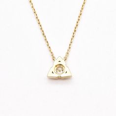 Diamond Triangle Necklace set with Natural Diamond, size 3 millimetres diameter, 0.12 Carats. Solid 14k Yellow Gold ☞ made to last. Click here for ☞ Solid Gold Collection Diamond Details: • CERTIFIED Natural Diamond • Weight: 0.12 Carats • Dimensions: 3mm • Color: G • Clarity: I1 • Cut: Very Good • Fluorescence: Yes Solid Gold Details: • 2 grams of 14k Solid Yellow Gold • Dimensions: Length ≈ 16in to 18in • Lasts a lifetime - Perfect for everyday use (won’t tarnish) *Final weight & dimensions de Minimalist Triangle Gold Jewelry, Elegant Triangle Yellow Gold Jewelry, Luxury Yellow Gold Triangle Jewelry, Triangle Yellow Gold 14k Jewelry, Elegant Triangle Yellow Gold Necklace, Minimalist Necklace Gold, Gold Letter Necklace, Triangle Necklace, Triangle Pendant