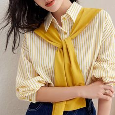 Discover Your New Favorite Wardrobe Staple Step into the season with style and comfort with our Yellow Striped Casual Button-Down Shirt, meticulously crafted to elevate your everyday look. Whether you're updating your office attire or adding a classic piece to your casual ensemble, this shirt is the perfect blend of elegance and practicality. Elegant Design Meets Premium Comfort Designed with the modern woman in mind, this shirt features a chic stand collar and a flattering straight cut that complements any body type. The breathable blend of cotton and polyester ensures both comfort and durability, making it ideal for the transitional weather of spring and autumn. Its subtle yellow stripes provide a splash of color, while the clean, buttoned front maintains a sleek, professional look. Prod Yellow Spring Office Tops, Yellow Summer Office Shirt, Casual Yellow Office Blouse, Yellow Long Sleeve Office Tops, Casual Yellow Office Shirt, Yellow Button Up Shirt, Comfort Design, Office Attire, Professional Look