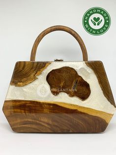 a handbag made out of wood with a bear carving on the front and side