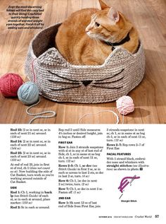 an orange cat is laying in a basket with balls of yarn on the floor next to it