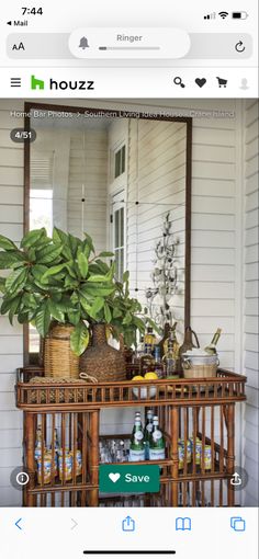 an image of a house with plants on the table and other items in front of it