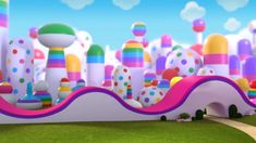 an animated image of a colorful city with lots of dots and rainbows on it