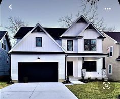 a white two story house with black shutters