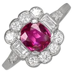 This exquisite vintage platinum ring features a captivating natural cushion-cut ruby, weighing approximately 1.30 carats, as its centerpiece. The ruby is elegantly flanked by baguette-cut diamonds, enhancing its refined allure. Adding to its timeless charm, the ring showcases a floral motif reminiscent of the Edwardian era, with round brilliant-cut diamonds set above and below the central stone. Additionally, smaller round brilliant diamonds adorn the shoulders, completing the ring’s sophisticat Cushion Cut Engagement Ring Halo, Vintage Platinum Rings, Cushion Cut Engagement, Alberto Giacometti, Engagement Ring Diamond, Cushion Cut Engagement Ring, Ruby Engagement Ring, Baguette Cut Diamond, Ruby Stone