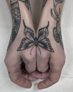 two hands with butterfly tattoos on them