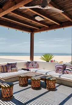 an outdoor living area with couches and tables