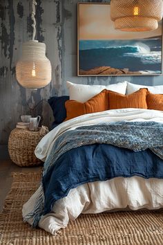 a bed with blue and orange linens in a bedroom next to a painting on the wall