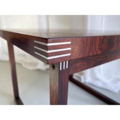 a close up of a wooden table with white lines on the top and bottom edge