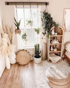 a room filled with plants and potted plants next to a white window sill