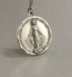 Check out this item in my Etsy shop https://www.etsy.com/listing/690111074/lrg-vintage-sterling-immaculate-mary Vintage Nickel Free Necklaces For Commemoration, Personalized Vintage Jewelry For Commemoration, Collectible Jewelry With Miraculous Medal Round Pendant, Vintage Charm Necklaces For Commemoration, Vintage Charm Necklace For Commemoration, Vintage Charms Necklace For Commemoration, Collectible Round Miraculous Medal Jewelry, Vintage Round Necklace With Miraculous Medal, Mary Necklace Silver