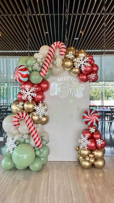 an arch made out of balloons and christmas decorations