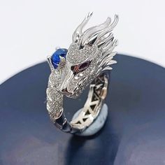 🎁Don't forget to buy some for your family or friends as it's an unique gift idea.❤️Dragon is a symbol of wealth and good luck 🐉💸 Give this beautiful dragon ring to your beloved and wish her/him all the best 💝💝.This is a stunning handmade piece of work where every detail is scrutinized.As a result, our dragon is finely modeled with an unmistakable pattern of dragon scales. Everyone will be fascinated by our dragon ring, which will add to the mystique of the person who wears it.Elevate your s Collectible Dragon Design Jewelry Ring, Collectible Dragon Design Ring, Round Dragon Design Jewelry For Gifts, Dragon Design Ring Jewelry For Gift, Dragon Design Ring Jewelry Gift, Dragon Design Jewelry For Gift, Dragon Design Jewelry Gift, Unique Snake Ring With Dragon Design Gift, Unique Sterling Silver Ring With Dragon Design