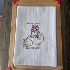 an embroidered dish towel with a chicken on it