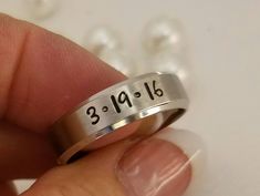 "Truly a beautiful Stainless Steel ring. It is a comfort fit and is 8 mm wide. It has a brushed flat surface with a shiny beveled rim. This ring also comes in 4 and 6 mm widths, and also sold as sets on my page. Add names/dates/quotes/scripture/coordinates or roman numerals. Stainless steel never tarnishes, rusts, changes color and is hypoallergenic. A comfort fit ring goes on like silk and is very comfortable. I hand stamp each letter than use the best quality black jewelry paint, clean and pol Personalized Stainless Steel Engraved Ring For Promise, Stainless Steel Ring With Brushed Finish As Gift, Stainless Steel Ring With Brushed Finish For Gift, Brushed Finish Stainless Steel Rings For Gift, Stainless Steel Promise Ring With Engraving Option, Stainless Steel Ring With Engraving Option For Promise, Stainless Steel Engraved Ring For Promise, Stainless Steel Engraved Ring For Anniversary, Stainless Steel Engraved Anniversary Ring