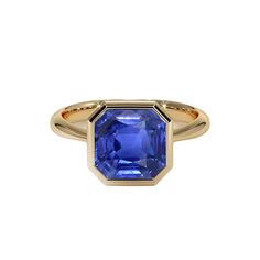 Yellow gold bezel set Ceylon Sapphire solitaire ring. METAL SPECIFICATIONS Yellow Gold 14K STONE SPECIFICATIONS Stone Name : Blue Sapphire Stone Cut : Asscher Stone Details : There is one asscher cut blue sapphire approx. 5 carats (Approx. Size 11 x 10 mm). Natural earth mined stone. Quality of Sapphire : AAA Sapphire Treatment : Heated Total : Approx. 5 Carats RING SPECIFICATIONS Size : 6.5 (Can ship in any size, please send us a message about size after placing the order) Appraised Value : $37 Asscher Engagement Ring, Ceylon Sapphire Ring, 5 Carat Ring, Blue Sapphire Stone, Sapphire Solitaire Ring, Yellow Gold Solitaire, Sapphire Solitaire, Ceylon Sapphire, Asscher Cut