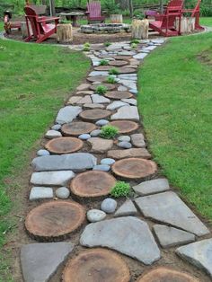 a stone path made out of logs with chairs in the background