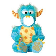 a blue monster stuffed animal with orange and yellow spots on it's chest, sitting in front of a white background