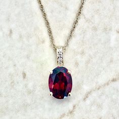 14K Gold Diamond & Garnet Pendant Necklace - 14K Yellow Gold Oval Garnet Necklace - January Birthstone Necklace - Best Birthday Gift For Her Beautiful and classic 14 karat yellow gold pendant necklace featuring a natural 8x6 mm oval garnet the birthstone for January!  The gemstone weighs approximately 1.50 carat.  It is accented with 4 diamonds weighing approximately 0.02 carat.  The pendant comes with a lightweight 14 karat yellow gold rope chain.  The chain measures 18 inches and is 0.90 mm thick.  Birthstone: January. Condition: Brand New. - 14-day return policy, no questions asked. * - Free insured shipping in the US. - International shipping available. Note: All items have been appraised and inspected by a jewelry specialist and certified gemologist (GIA GG). All diamond and gemstone Oval Gemstone Birthstone Necklace For Formal Occasions, Oval Birthstone Necklace For Anniversary, Anniversary Birthstone Necklace With Oval Pendant, Anniversary Oval Pendant Birthstone Necklace, Oval Gemstone Birthstone Necklace For Anniversary, January Birthstone Necklace, Smoky Quartz Jewelry, Gemstone Rings Vintage, December Birthstone Jewelry