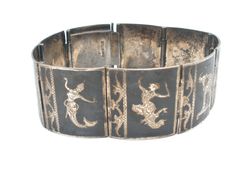 Enamel Jewelry - This is a sterling silver black enamel Niello panel bracelet with elephants and dancers. It is 7" long, .88" wide, hallmarked Sterling Siam and weighs 34.2 grams. The bracelet has original patina and a hidden slide in locking clasp. Traditional Black Engraved Bracelets, Bracelet Vintage, Slide In, Enamel Jewelry, Black Enamel, Vintage Black, Cuff Bracelets, Patina, Bracelet