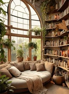 a living room filled with lots of plants and bookshelves next to a large window