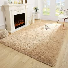 a living room with white furniture and a fireplace