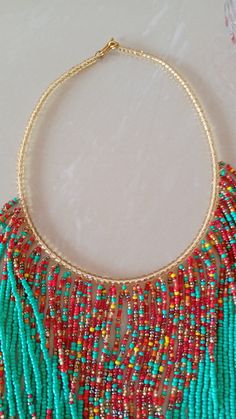 African Beaded Fringe Necklace, Multistrand Necklace, Beaded Jewelry, Women Jewelry, Tribal Necklace, African Jewelry, Gift For Her This statement necklace is superbly crafted which makes you stand out. Main color - turquoise green. Closure: hook Available in different colors, please contact me. Neck width: 17 inches Fringe width 16 inches 3-5 days delivery via DHL Express Colors of your choice can be customized,please contact me. Feel free to send me a convo or e-mail for any clarification or m Multi-strand Dangling Beads For Gift, Dangling Multi-strand Beads For Gifts, Festive Multi-strand Beaded Necklaces, Multi-strand Beaded Necklace With Dangling Beads For Gift, Multi-strand Necklaces With Spacer Beads For Jewelry Making, Handmade Multi-strand Beads For Festive Occasions, Handmade Multi-strand Festive Beads, Tiny Beads Bib Necklaces For Jewelry Making, Festive Handmade Multi-strand Beads