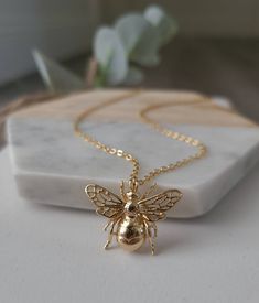 This listing is for a beautiful 14K gold filled Bee Charm Necklace! This stunning bee pendant comes on a 16, 17.5 or 19 inch cable chain. A 2 inch extender can be added. This piece will not tarnish, fade or flake! This unique bee pendant necklace is fun, cute, and perfect for spring and summer! Bee measures 2cmx2.5cm See listing for matching earrings here https://www.etsy.com/listing/984786778/14k-gold-filled-bee-earrings-bumble-bee?ref=shop_home_feat_3 W H A T ∙ I S ∙ G O L D ∙ F I L L E D? Gol Honey Bee Jewelry, Fantasy Earrings, Small Bees, Bee Jewelry, Bee Pendant, Gold Bee, Bee Necklace, Bee Earrings, Bee Charms