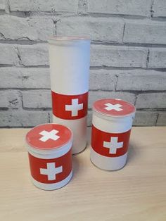 three plastic cups with red and white crosses on them