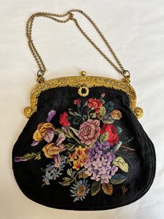 A superb and rare piece.  Heavily embroidered in the tiniest stitching creating a flourish of flowers on both sides of this purse made of black velvet..  An elaborate gold tone frame with Made in France stamp. Silk lined with a small mirror encased in silk with a tiny ruffle attached to the inside pocket. Has a chain that is double or longer single.  In excellent condition bar wear to lining.   A museum quality piece. See photos for measurements Vintage Floral Embroidery Bags For Formal Occasions, Gold Evening Bag With Floral Embroidery, Gold Velvet Evening Bag, Vintage Floral Embroidered Bag For Formal Occasions, Formal Embroidered Velvet Bag, Embroidered Velvet Evening Bag, Vintage Floral Embroidery Formal Bags, Vintage Embroidered Evening Bags, Vintage Formal Bag With Floral Embroidery