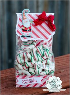 a bag filled with white and red candy canes on top of a wooden table