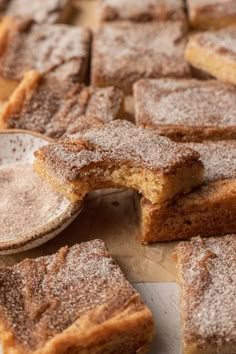 several pieces of cake sitting on top of a wooden cutting board