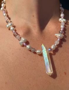 This beautiful one of a kind necklace is super unique and fit for any fairy, angel babe, or cottage core princess!!  Featuring a funky mix of glass beads, lavender and lilac dyed seed pearls, natural white freshwater pearl beads of various sizes and shapes, and a stunning central angel aura quartz point with irridescent, hooographic rainbow flashes in the light!! All metal components (charm, lobster claw closure, chain for adjustable length) are pure stainless steel. Safe for sensitive skin.   1 Beaded Necklace White, Rave Jewelry, Colorful Beaded Necklace, Dope Jewelry Accessories, Rave Accessories, White Lavender, Hippy Gifts, Angel Aura Quartz, Angel Aura