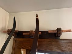 two large knives are hanging on the wall