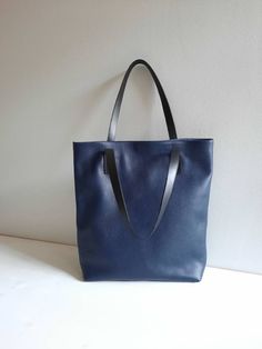 "This hand bag is crafted from textured soft leather in navy blue. It's the ideal size for taking you from desk to dinner, and can be worn over the shoulder for hands-free. - Two shoulder straps. - Pleated top with magnetic fastening. - You can choose from 6 leather colors. - Cotton lining with zip close compartment for securing your necessities and one open interior pocket, you can choose from 7 different lining colors. Free delivery is economic delivery. We use Latvian post and delivery can ta Beige Tote, Slouchy Bag, Soft Leather Bag, Genuine Leather Totes, Blue Tote, Black Leather Tote, Genuine Leather Bags, Perfect Bag, Leather Tote Bag