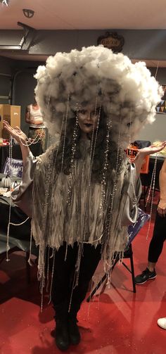 a woman is dressed up as a cloud