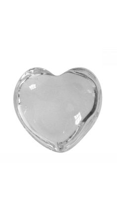 a glass heart shaped dish on a white background