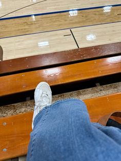 a person with their feet up on a basketball court