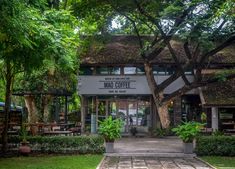 the entrance to mad coffee in front of some trees