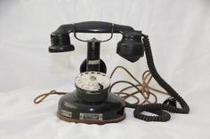 an old - fashioned telephone is sitting on a white sheet