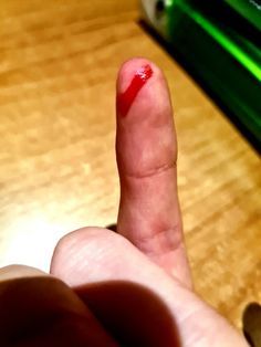 a finger with a red substance on it