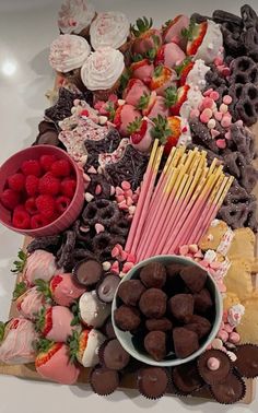 a platter filled with lots of different types of desserts and pastries on top of a table