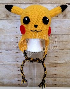 a crocheted pikachu hat on top of a white mannequin