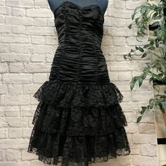 This Beautiful Betsey Johnson Black Dress Is Made Of Silk, The Size 8 From Y2k Is Like A Current Size Small. It Is Very Beautiful. The True Black Color Is Shown On Picture 1, 2. And 3. It's In Original Condition With Tag. Dress Length Is 33". Pit To Pit At The Top Is About 15.5. The Top Part Is Like A Corset. The Strap Is Attached In A Bag So You Can Wear It Or Without It. Lace Up Dresses, Goth Homecoming Dress, Vintage Gothic 90s Prom Dress, Betsey Johnson 90s Dresses, Betsey Johnson Runway 2000s, Betsey Johnson Vintage Dress, Betsey Johnson 1997, Black Tiered Dress, Flared Skirt Dress