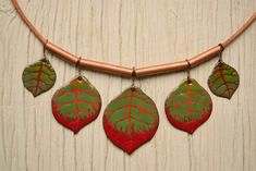 Enamel Necklace, Leaf Statement Necklace, Tree Necklace, Forest Necklace, Leaf Necklace, Bib Necklace, Statement Necklace, Red and Green, This is an enamel summer jewelry. It's imitating the leaf of the alder tree. This is a summer fashion jewelry but not only for summer. Perfect for any fan of enamel jewelry, or those who just love colour, this enamel necklace is entirely handmade by me. The colours are happy and joyful moods, like a pleasant sunny day.  The graphics is painted with vitreous enamel and used sgraffito technics (scratch work). The form of the pendant is cutted by hand with shear. Both side of the shape is enamelled, the back side is covered with black. Absolutely handmade unit. Shipping Informations. To Europe the delivering time is about 4-5 workdays, to USA about 12-14 wo Handmade Red Enamel Necklaces, Handmade Red Enamel Necklace, Red Handmade Enamel Necklaces, Red Hand Painted Pendant Necklaces, Alder Tree, Forest Necklace, Necklace Leaf, Necklace Tree, Enamel Necklaces